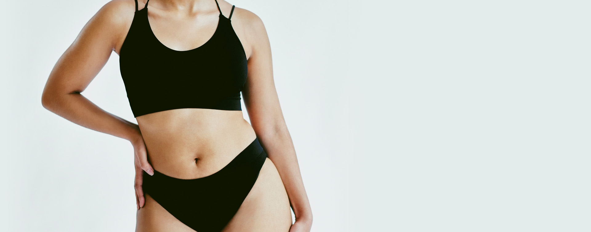 Woman in bathing suit with hand on hip