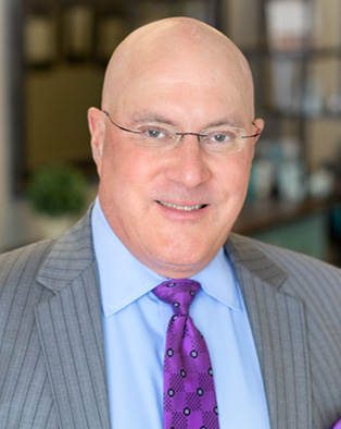 Dr. Lucas smiling at camera