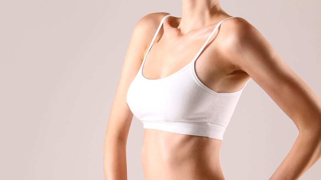Woman in sports bra standing with hand on hip