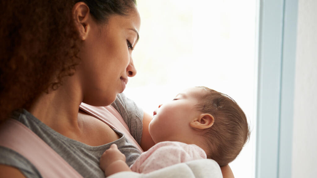 Mother holding a sleeping baby