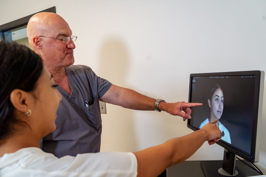 Dr. Jay Lucas reviewing VECTRA 3D facial imaging with a patient during a consultation at The Lucas Center in Knoxville